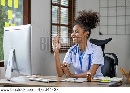American Female Doctor Is Video Chatting With A Patient, She Is A General Practitioner And Internal