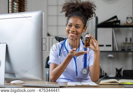 American Female Doctor Is Video Chatting With A Patient, She Is A General Practitioner And Internal