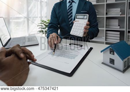 Real Estate Agent And Customer Make Contract To Buy And Sell House And Land. Approval Of A Contract 
