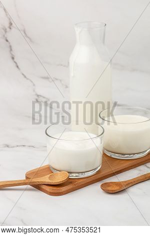 A Bottle Of Milk And Glass Of Yogurt, Kefir, Fermented Milk, Probiotic Cold Fermented Dairy Drink. T