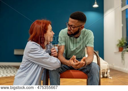 Unhappy Serious Interracial Couple Young Man And Woman Talking About Relationships, Wife And Husband