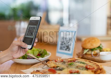 Woman Use Smartphone To Scan Qr Code To Pay In Cafe Restaurant With A Digital Payment Without Cash. 