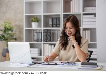 Portrait Of Smiling Beautiful Business Asian Woman Working In Office Use Computer With Copy Space. B
