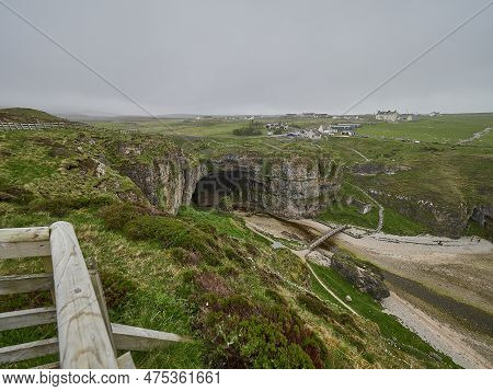 Entrance Of Smoo Cave At The Coastline Of The Atlantic Ocean In Northern Scotland.