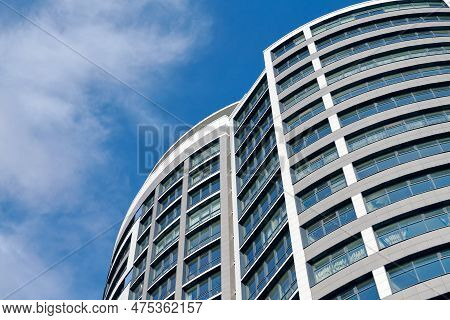 Office Skyscraper High Business Building On Blue Sky Background, Looking Up Tall Glass Windows And S