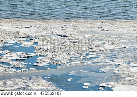 Melting Sea Ice Seasonal Natural Phenomenon Of Coming Spring, Ice On Water Melts From Burning Sun. W
