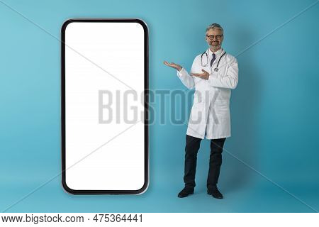Friendly Middle Aged Doctor Showing Nice Telemedicine App
