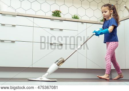 Side View Of Cute Little Preteen Girl With Long Dark Hair Wearing Blue T-shirt, Pink Leggings, Big B