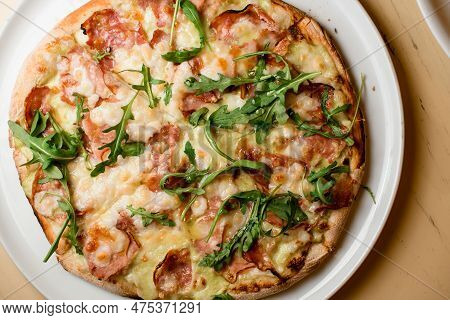 Ready-made Mini Pizza With Jamon, Ruccola Covered With Cheese On Light Table