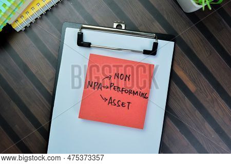 Concept Of Npa - Non Performing Asset Write On Sticky Notes Isolated On Wooden Table.