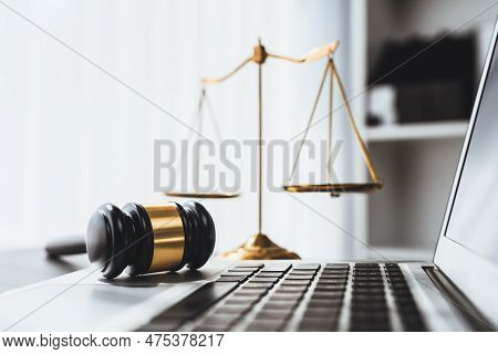 Symbolizing Justice And Legal Authority, Golden Balanced Scale And Gavel On Desk With Laptop In Law 