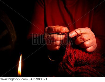Hand Knitting With Woolen Thread By Candlelight. Knitting Needles. Woolen Thread. Old Man's Hands. H