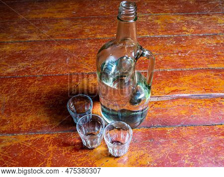 Glass Bottle For Vodka With A Handle And Glasses. Neck Of A Glass Bottle. Alcohol. Glassware For Alc