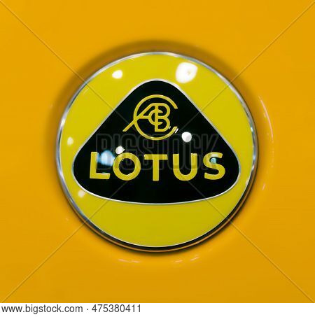 Toronto, Canada - 02 25 2023: Yellow Rounded Logo Of Lotus Cars Limited On Orange Hood Of Lotus Spor