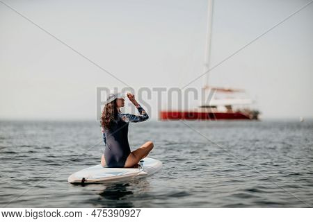 Woman Sup Yoga. Middle Age Sporty Woman Practising Yoga Pilates On Paddle Sup Surfboard. Female Stre