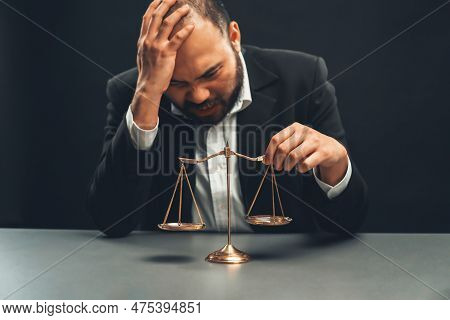 Focus Scale Balance With Blur Lawyer Sitting At His Desk With Worried And Exhausted Expression, Feel