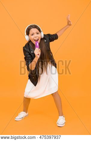 Online Karaoke Singing. Music In Wireless Earphones. Kid Use Comb As Microphone. Child Listen Music 