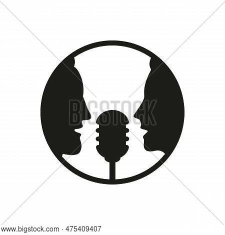 A Man And A Woman Speak Into A Microphone.