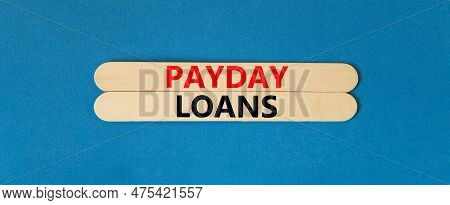 Payday Loans Symbol. Concept Words Payday Loans On Beautiful Wooden Stick. Beautiful Blue Table Blue