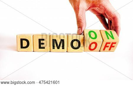 Demo On Or Off Symbol. Businessman Turns Wooden Cubes And Changes Word Demo Off To Demo On. Beautifu