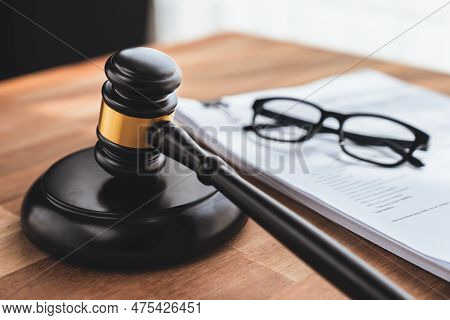 Black Wooden Gavel Hammer And Legal Document In Empty Law Firm Or Lawyer Office Background As Justic