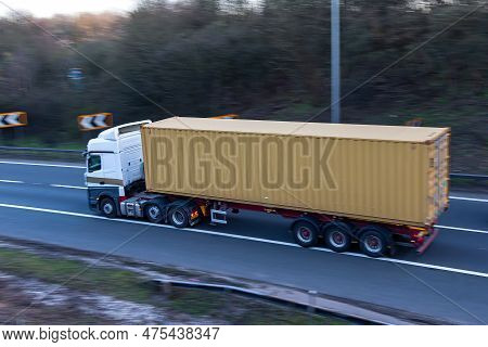 Lorry Carrying Shipping Conteiner Travelling On The British Motorway.