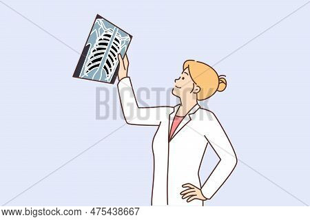 Woman Doctor Examines X-ray Of Person Chest In Search Of Symptoms Of Dangerous Diseases. Girl Doctor
