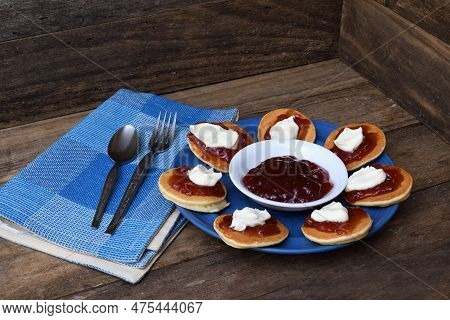Pikelets/pancakes/battercakes With Strawberry Jam And Whipped Cream On A Blue Plate With Napkin, Spo