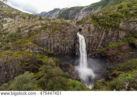 Waterfall In Norway With Mountains. Manafossen. Flowing Water