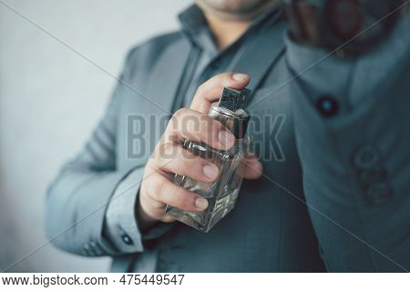 Businessman In A Formal Suit Use Cologne Or Perfume. Male Perfume. Successful Businessmen Like Perfu