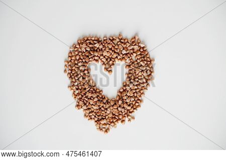 Buckwheat Grain Heart On White Background. Healthy Superfood Diet