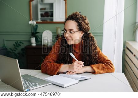 Remote Learning And Working: Young Female Student Studying Online With Laptop At Home Office. Effect