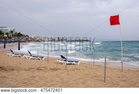 Red Flag On The Stormy Beach. Dangerous For Swimming. Fig Tree Bay Protaras Cyprus