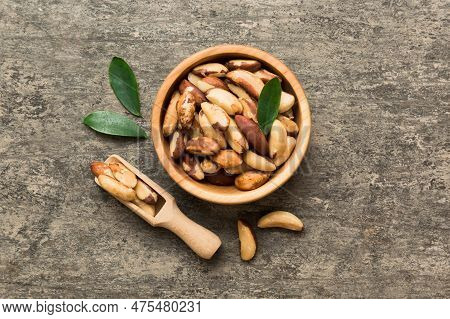 Fresh Healthy Brazil Nuts In Bowl On Colored Table Background. Top View Healthy Eating Bertholletia 
