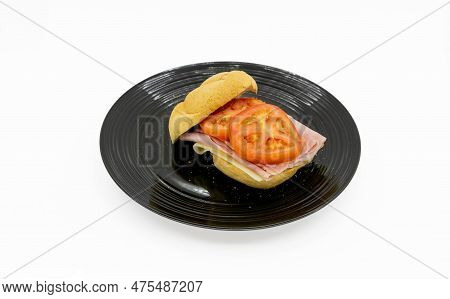 A boiled ham and alpine swiss cheese sandwhich on a black plate