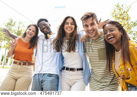 Low Angle View Of A Happy Group Of Multiracial Friends Looking At Camera, Enjoying Outdoors. Multiet
