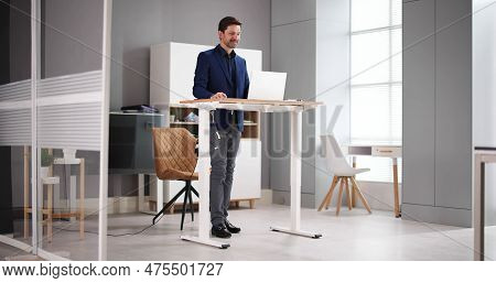 Adjustable Height Desk Stand In Office Using Computer