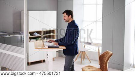 Adjustable Height Desk Stand In Office Using Computer