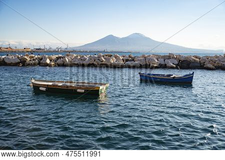 Vesuvius Seen And Fish Boats From The Seafront Of Naples In Italy