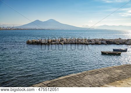 Vesuvius Seen And Fish Boats From The Seafront Of Naples In Italy