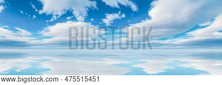 Sky Reflections In Water. White Clouds In Blue Sky Over Water. Reflection Of White Clouds And Blue S