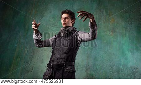 A Young Man In A Victorian-style Suit, A Retro Character. Antihero Or Tragic Character Makes Magical