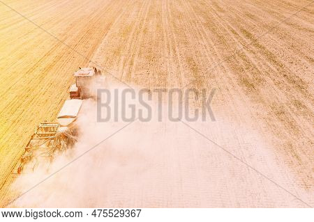 Elevated View Tractor With Seed Drill Machine Sowing Seeds For Crops In Spring Season. Beginning Of 