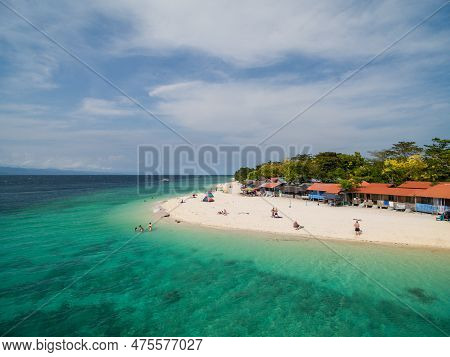 White Beach Moalboal In Cebu, Palawan, Philippines. Boat And Ocean Water And Beach. Drone
