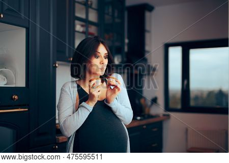 Funny Pregnant Woman Holding Muffins In The Kitchen
