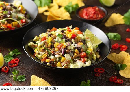 Mexican Style Salad Of Black Beans, Lentils, Corn, Tomato And Lettuce With A Salsa And Tortilla Chip