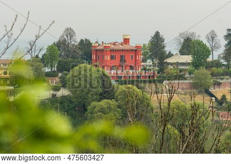 Panoramic View Of The Hills With Green Vegetation And A Red Castle Or Building From San Sebastiano D