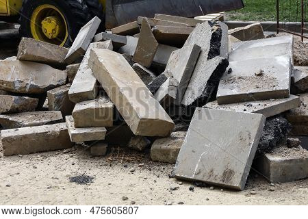 Construction Waste. A Pile Of Cement Pressed Materials, Concrete Debris, Of Grey Slabs, Curbs And Ru