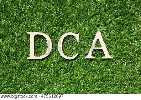 Wood Alphabet Letter In Word Dca (abbreviation Of Dollar-cost Averaging) On Artificial Green Grass B
