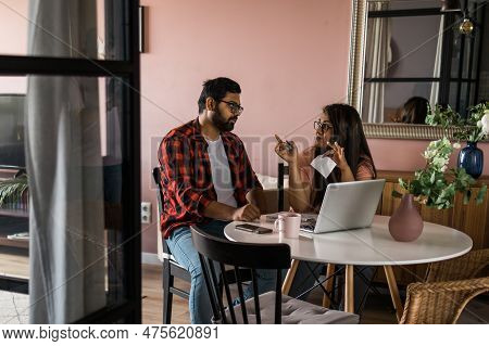 Serious Wife And Husband Planning Budget, Checking Finances, Focused Young Woman Using Online Calcul